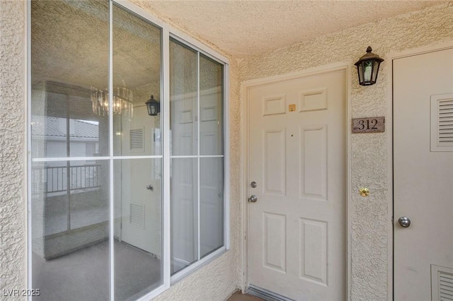 entrance to property with stucco siding