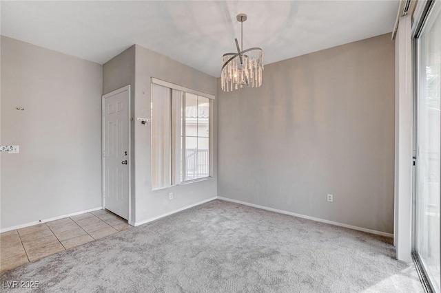 unfurnished room with carpet, tile patterned flooring, baseboards, and an inviting chandelier