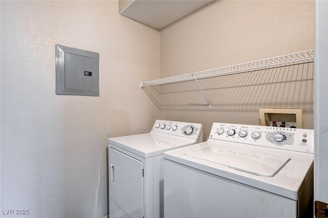 washroom featuring laundry area, electric panel, and separate washer and dryer