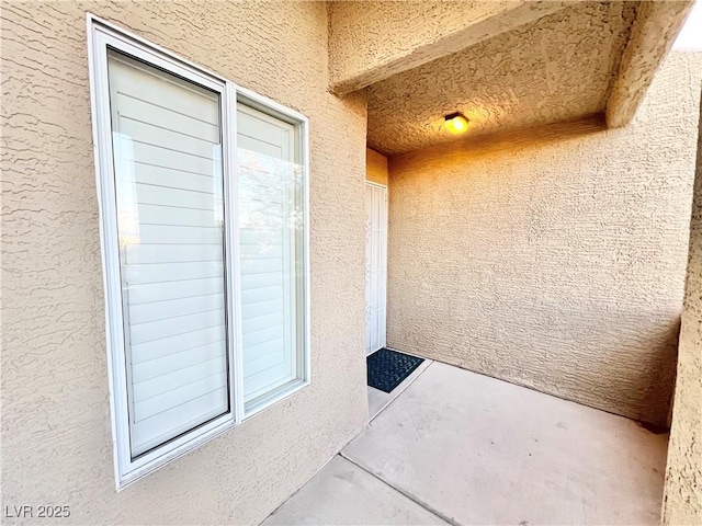 entrance to property featuring stucco siding