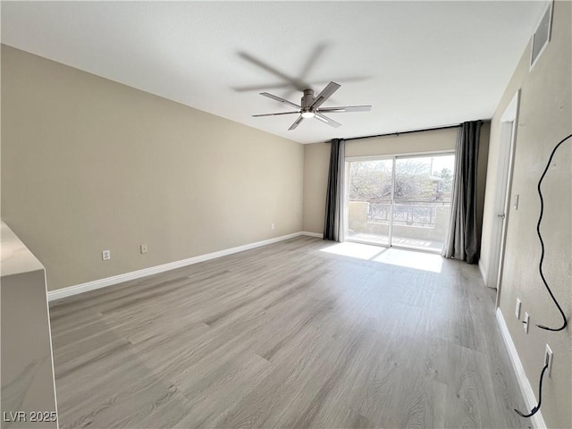 empty room with light wood-type flooring, baseboards, visible vents, and a ceiling fan