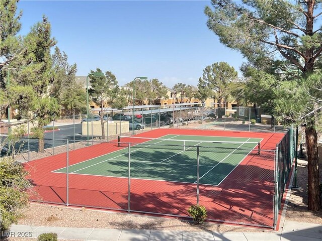 view of tennis court with fence