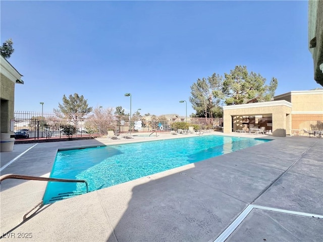 community pool featuring a patio area and fence