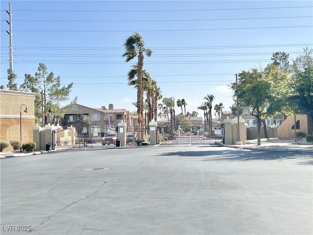 view of road with a residential view, a gate, and a gated entry