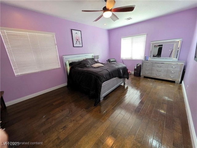 bedroom with visible vents, ceiling fan, baseboards, and wood-type flooring