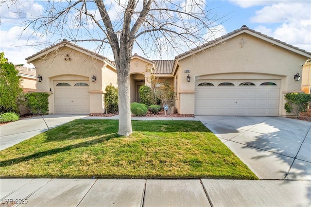 mediterranean / spanish-style house featuring an attached garage, driveway, and stucco siding