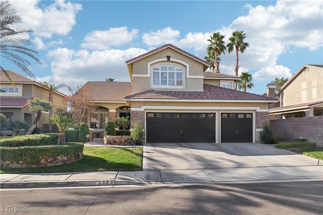 traditional-style house featuring driveway, fence, and stucco siding