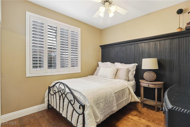 bedroom with a ceiling fan, baseboards, and hardwood / wood-style floors