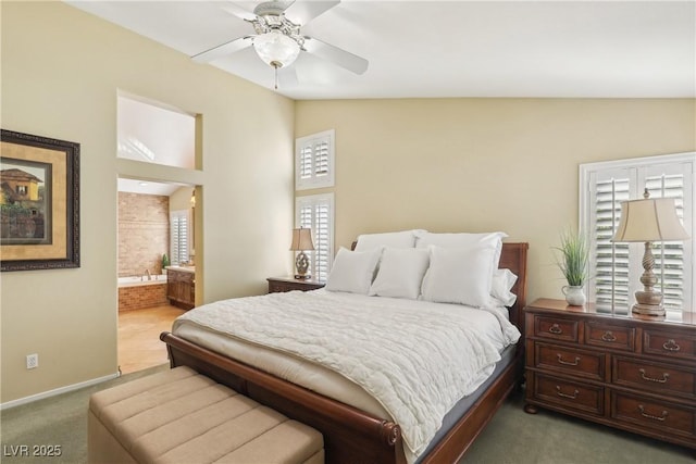 bedroom with lofted ceiling, carpet flooring, connected bathroom, ceiling fan, and baseboards