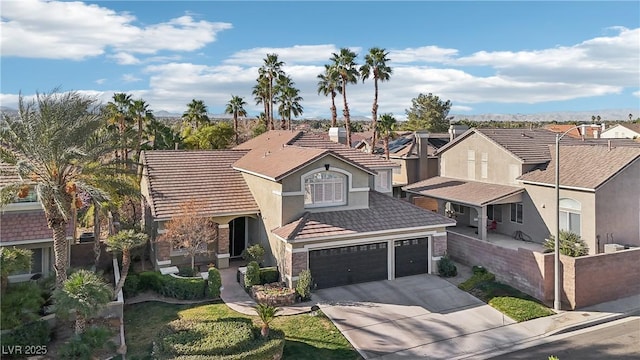 view of front of house featuring stucco siding, an attached garage, a residential view, driveway, and a tiled roof