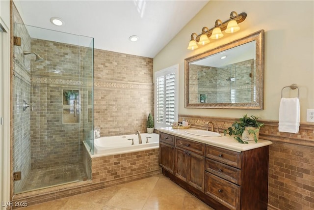 bathroom with a stall shower, vanity, a bath, and tile patterned floors