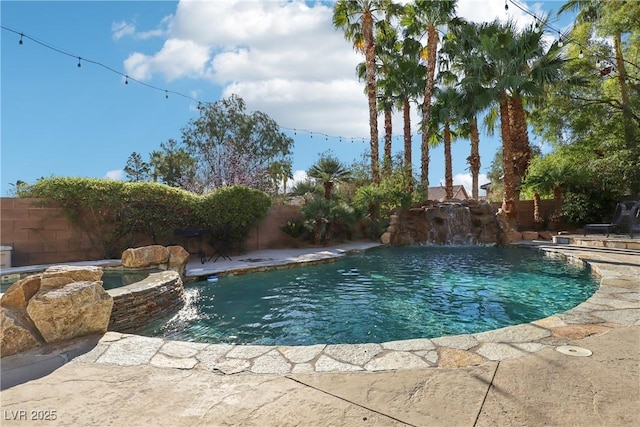 view of pool with a patio area, a fenced backyard, and a pool with connected hot tub