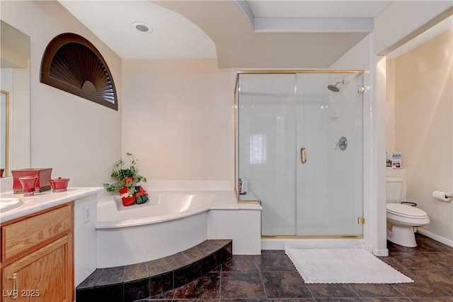 full bath featuring a garden tub, a shower stall, toilet, and vanity