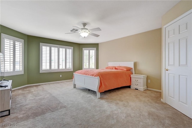 carpeted bedroom with ceiling fan and baseboards