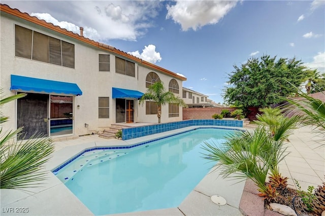 view of swimming pool with a patio area, fence, and a fenced in pool