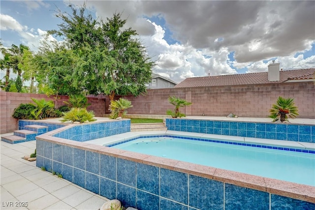 view of swimming pool featuring a fenced backyard and a patio