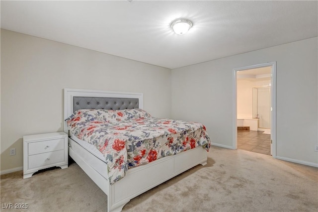 carpeted bedroom featuring baseboards and ensuite bathroom