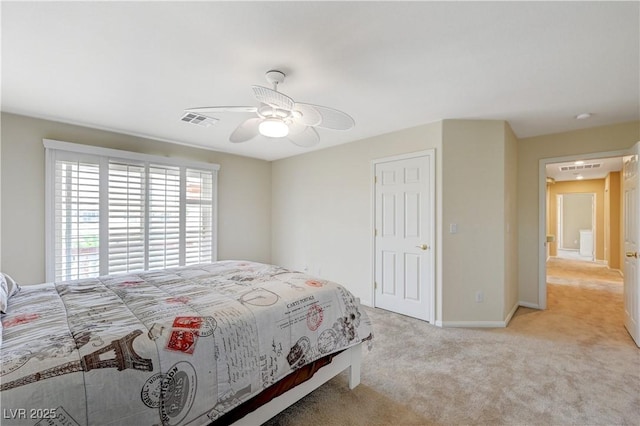 carpeted bedroom featuring ceiling fan, visible vents, and baseboards