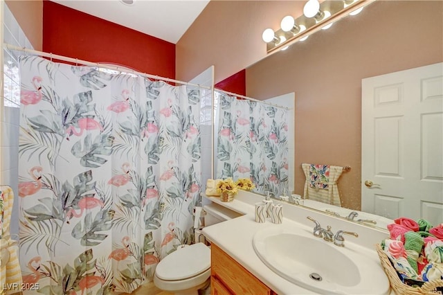 full bath featuring toilet, a shower with shower curtain, and vanity