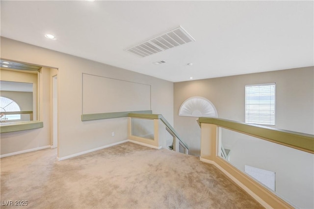 empty room with recessed lighting, carpet, visible vents, and baseboards