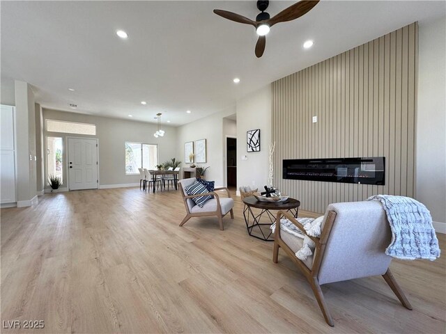 living area featuring recessed lighting, baseboards, light wood-style floors, and ceiling fan