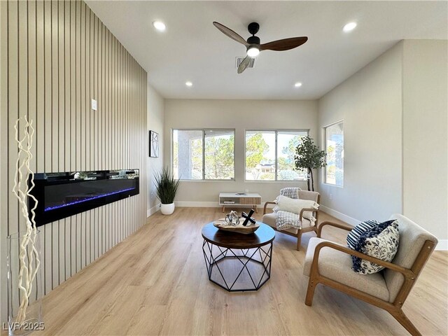 living room with recessed lighting, baseboards, plenty of natural light, and wood finished floors