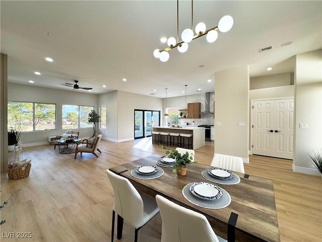 dining room featuring recessed lighting, visible vents, plenty of natural light, and light wood-type flooring