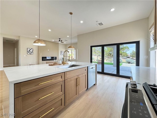 kitchen with dishwashing machine, visible vents, light wood-style flooring, recessed lighting, and a sink