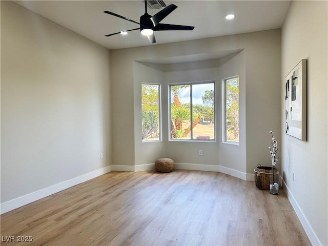 empty room with recessed lighting, a ceiling fan, baseboards, and wood finished floors