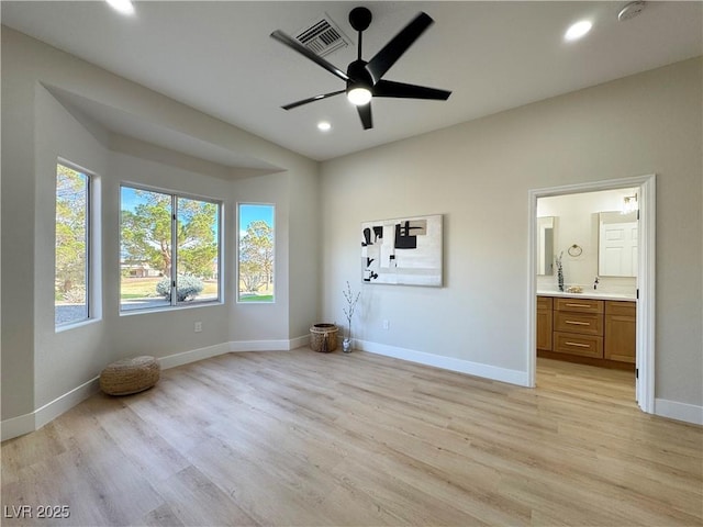 unfurnished bedroom featuring recessed lighting, light wood-style floors, and baseboards