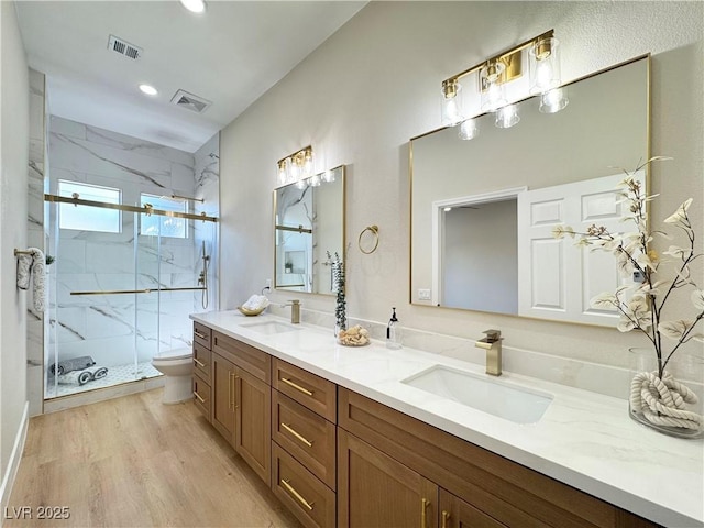 bathroom featuring toilet, visible vents, and a sink