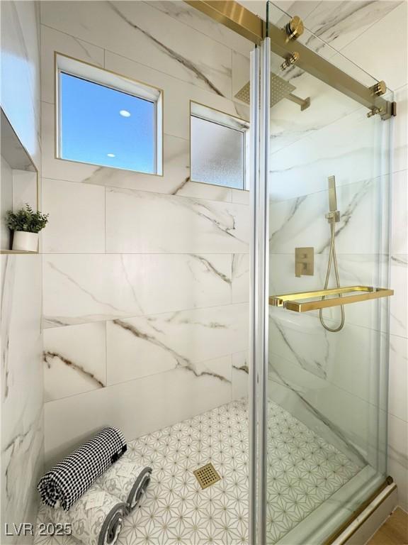 full bathroom with a marble finish shower