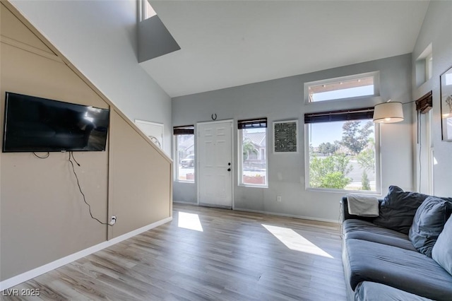 living room with plenty of natural light, light wood-style flooring, and baseboards