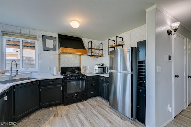 kitchen featuring custom range hood, a sink, black appliances, and dark cabinetry