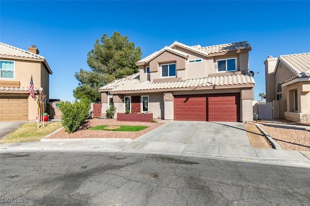 view of front facade with a garage, driveway, a tiled roof, fence, and stucco siding