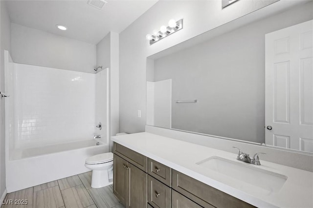 bathroom with toilet, shower / tub combination, visible vents, and vanity