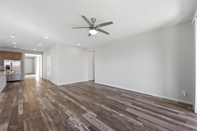 unfurnished living room with baseboards, a ceiling fan, dark wood-style flooring, and recessed lighting