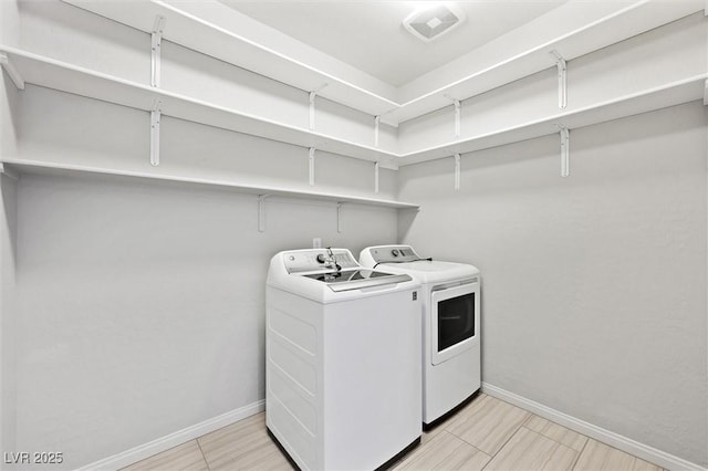 laundry room featuring washer and dryer, laundry area, visible vents, and baseboards