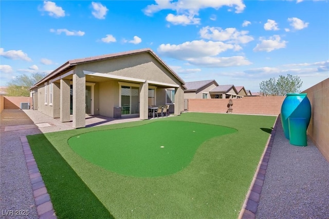 back of house featuring stucco siding, a fenced backyard, and a patio