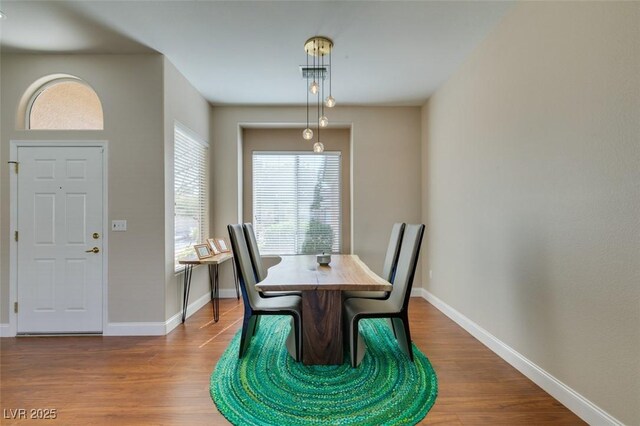 dining area with wood finished floors and baseboards