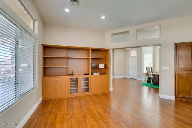 9816 Gerald Ct, Las Vegas, NV 89134 - unfurnished living room featuring healthy amount of natural light, light wood-type flooring, and recessed lighting