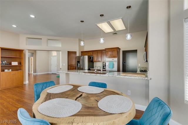 dining room featuring recessed lighting, wood finished floors, visible vents, and baseboards