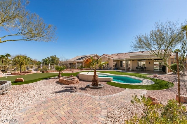9816 Gerald Ct, Las Vegas, NV 89134 - view of pool featuring a patio area, an outdoor fire pit, a fenced backyard, and a putting area