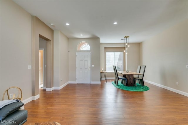 entryway featuring baseboards, wood finished floors, and recessed lighting