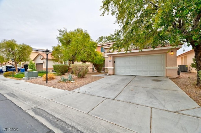 view of property hidden behind natural elements with central air condition unit, a garage, concrete driveway, and stucco siding