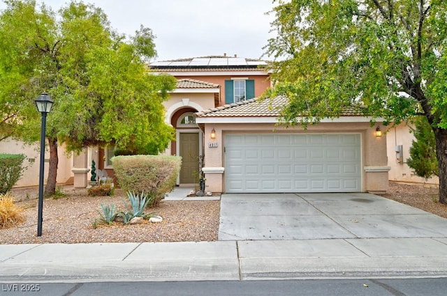 view of front of home with driveway, a tile roof, a garage, and stucco siding