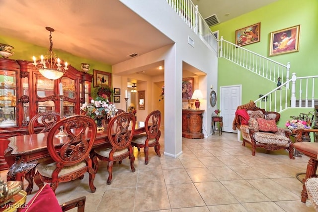 tiled dining room with stairway, visible vents, and a notable chandelier