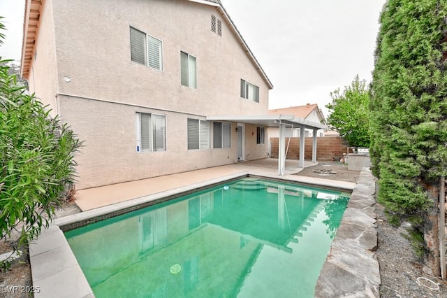 view of swimming pool featuring a patio area, a fenced backyard, and a fenced in pool