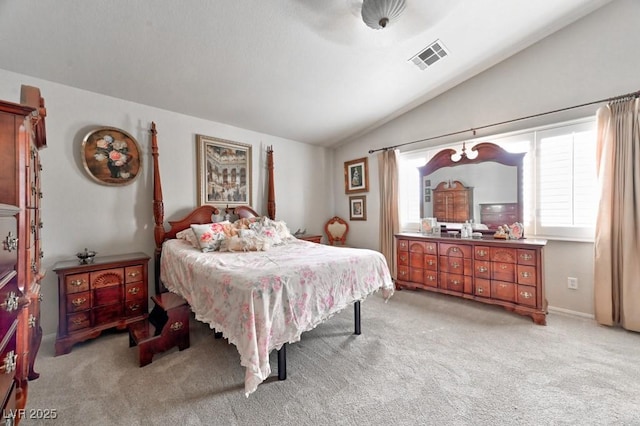 bedroom featuring lofted ceiling, light carpet, and visible vents