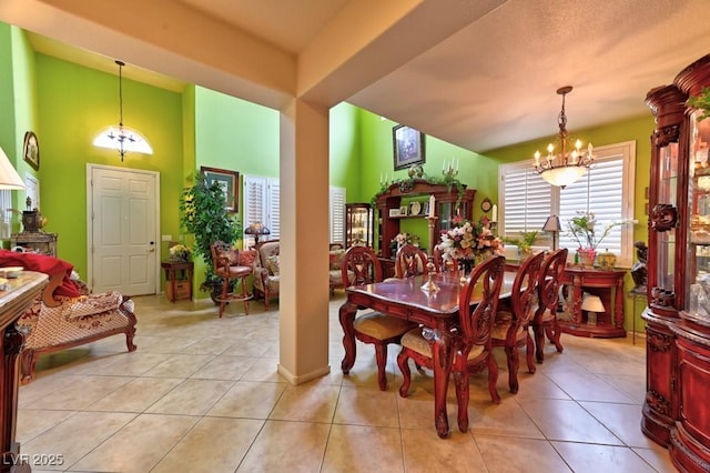 tiled dining area featuring an inviting chandelier